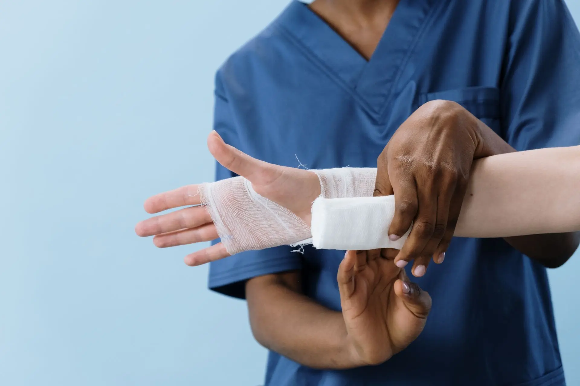 Nurse applying a dressing to a patient's hand